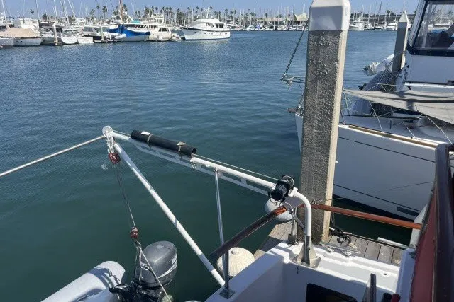 Slide: The Image of 1983 Roughwater 41 yacht docked in a marina with other boats. - 31