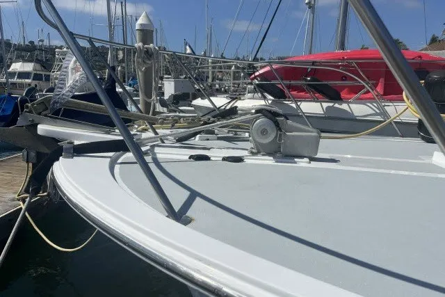 Slide: The Image of 1983 Roughwater 41 boat docked at marina, featuring deck and railing details. - 36