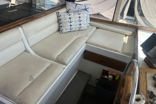 Slide: The Image of Interior seating area of a 1983 Roughwater 41 boat with anchor-themed cushions. - 27