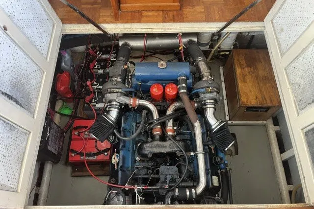 Slide: The Image of Engine compartment of a 1983 Roughwater 41 boat, showcasing detailed mechanical components. - 38