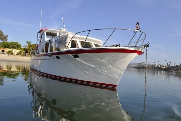 Slide: The Image of 1983 Roughwater 41 boat on calm water, showcasing sleek design and classic style. - 43