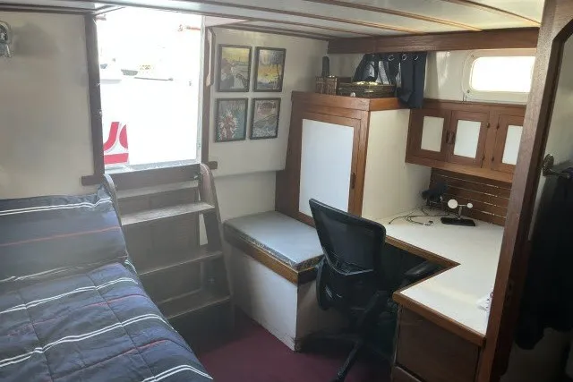 Slide: The Image of Interior of 1983 Roughwater 41 boat with bed, desk, and wooden cabinetry. - 17