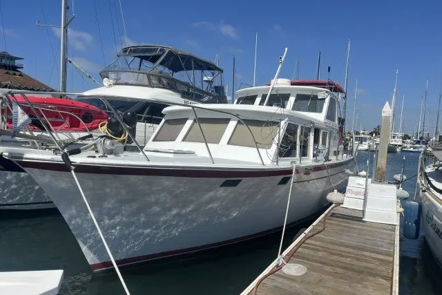 Slide: The Image of 1983 Roughwater 41 boat docked at marina under clear blue sky. - 37
