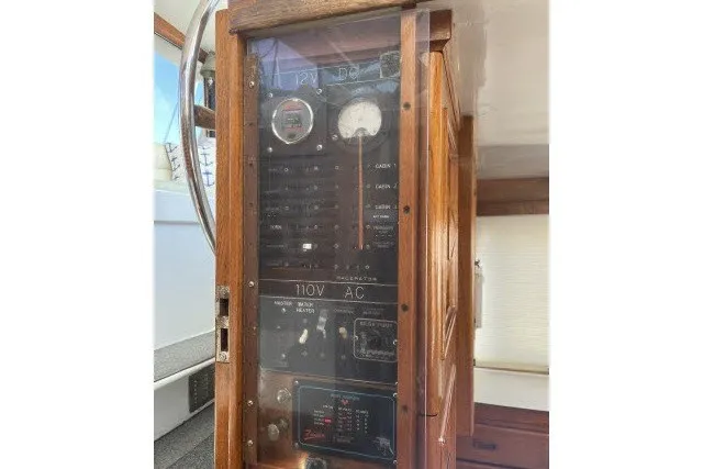 Slide: The Image of Electrical panel of a 1983 Roughwater 41 boat, featuring gauges and switches. - 26