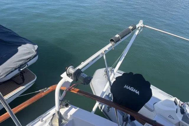 Slide: The Image of 1983 Roughwater 41 boat deck with Magma grill and calm water backdrop. - 30