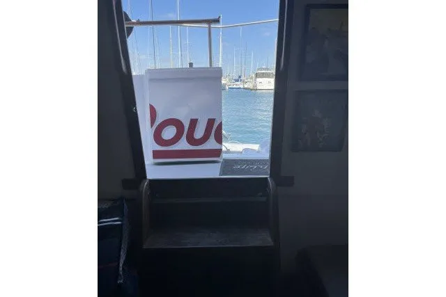 Slide: The Image of Interior view of 1983 Roughwater 41 boat with marina background. - 20
