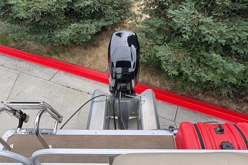 Slide: The Image of 2025 Sun Tracker Party Barge 16 DLX pontoon boat with outboard motor and red fuel tank. - 21