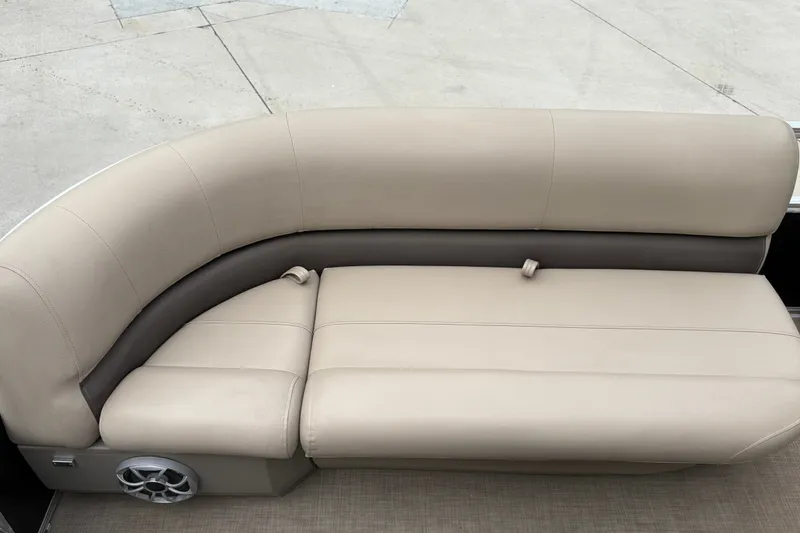 Slide: The Image of 2025 Sun Tracker Party Barge 16 DLX beige seating with speaker detail. - 28