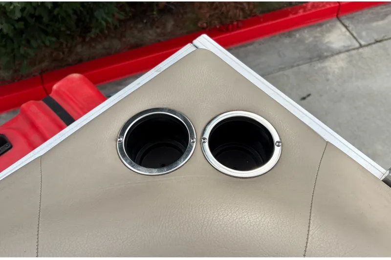 Slide: The Image of Cup holders on 2025 Sun Tracker Party Barge 16 DLX boat, beige upholstery. - 20