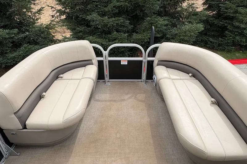 Slide: The Image of 2025 Sun Tracker Party Barge 16 DLX interior with beige seating and spacious layout. - 14