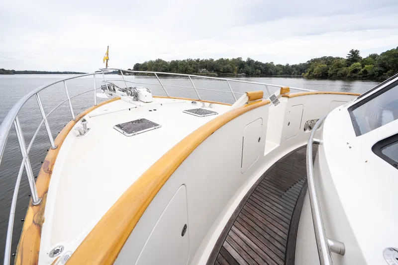 Slide: The Image of Bow view of 2009 Marlow 61C yacht on calm water, surrounded by trees. - 18