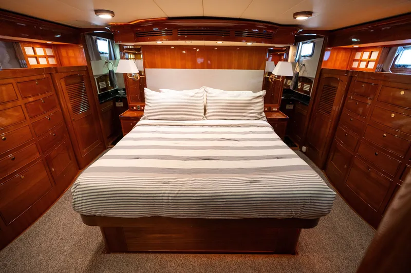 Slide: The Image of Luxurious Marlow 61C 2009 yacht bedroom with elegant wood finish and cozy bedding. - 105