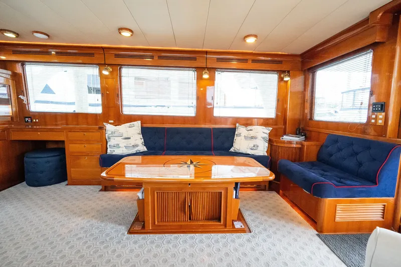 Slide: The Image of Luxurious 2009 Marlow 61C yacht interior with elegant wood finish and plush seating. - 30