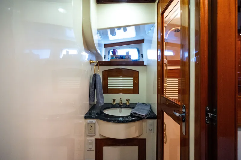 Slide: The Image of Luxurious Marlow 61C 2009 yacht bathroom with wooden accents and elegant fixtures. - 91
