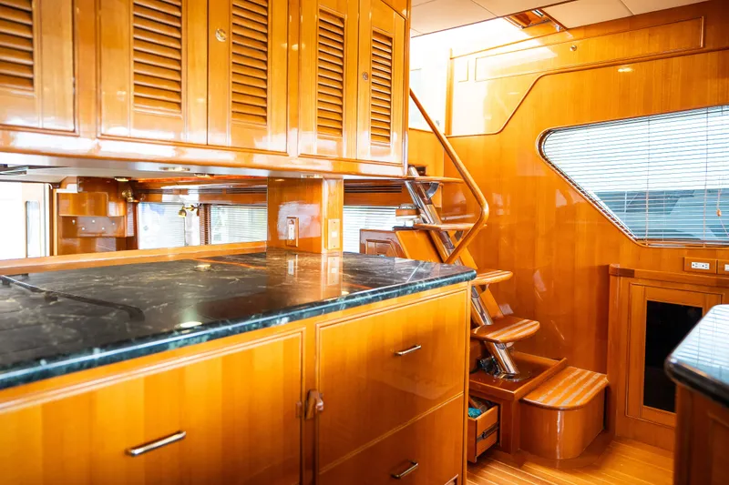 Slide: The Image of Luxurious wooden interior of 2009 Marlow 61C yacht with sleek cabinetry and staircase. - 57