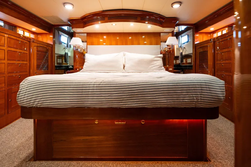 Slide: The Image of Luxurious cabin interior of a 2009 Marlow 61C yacht with elegant wood finishes. - 104