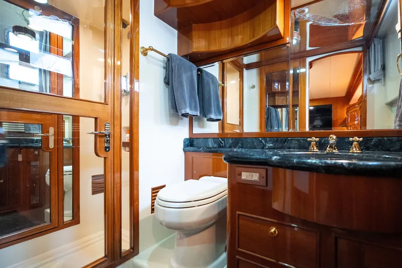 Slide: The Image of Luxurious Marlow 61C 2009 yacht bathroom with wood accents and elegant fixtures. - 117