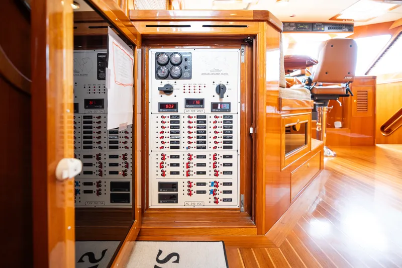 Slide: The Image of Electrical control panel inside a 2009 Marlow 61C yacht with polished wood interior. - 67