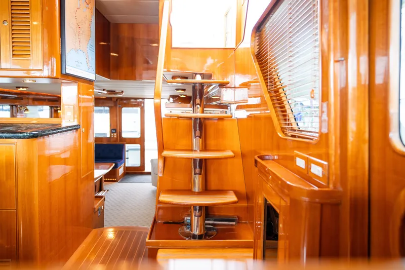 Slide: The Image of Luxurious 2009 Marlow 61C yacht interior with polished wood and elegant staircase. - 68