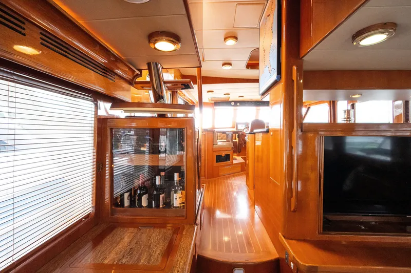 Slide: The Image of Luxurious interior of 2009 Marlow 61C yacht with wooden finishes and wine cabinet. - 40