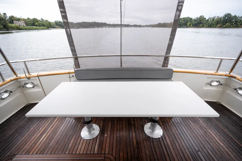 Slide: The Image of Outdoor seating area on 2009 Marlow 61C yacht with table and scenic water view. - 26
