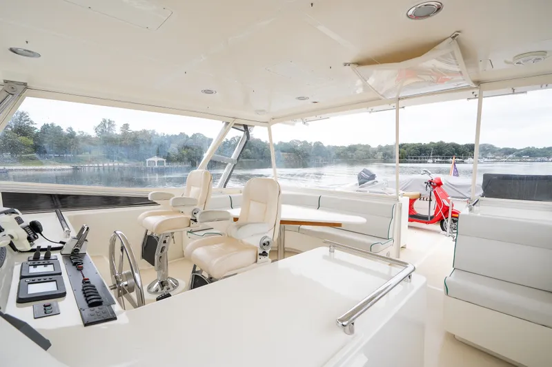 Slide: The Image of Interior view of a 2009 Marlow 61C yacht with luxurious seating and control panel. - 69