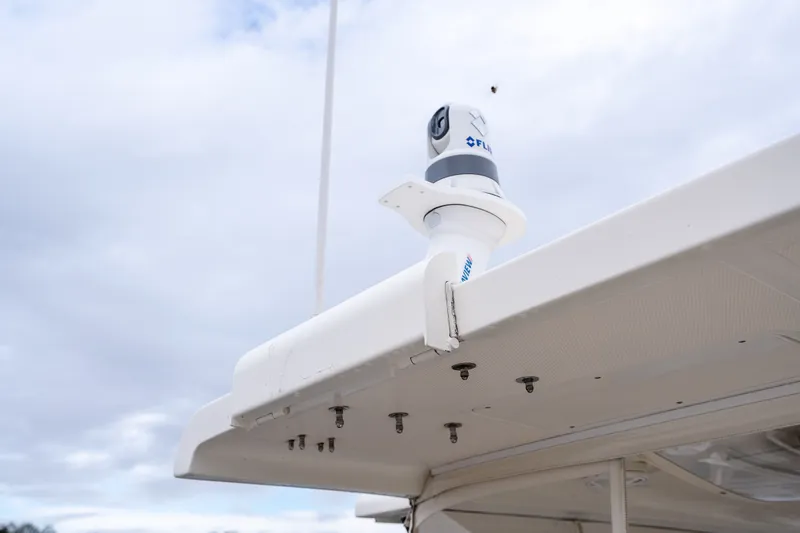 Slide: The Image of FLIR camera mounted on a 2009 Marlow 61C yacht under a cloudy sky. - 139