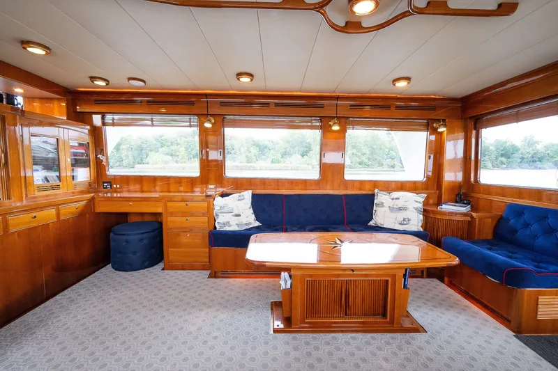 Slide: The Image of Luxurious 2009 Marlow 61C yacht interior with elegant wood finish and plush blue seating. - 39