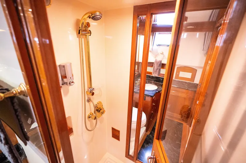 Slide: The Image of Luxurious bathroom in 2009 Marlow 61C yacht with elegant wood and gold fixtures. - 116