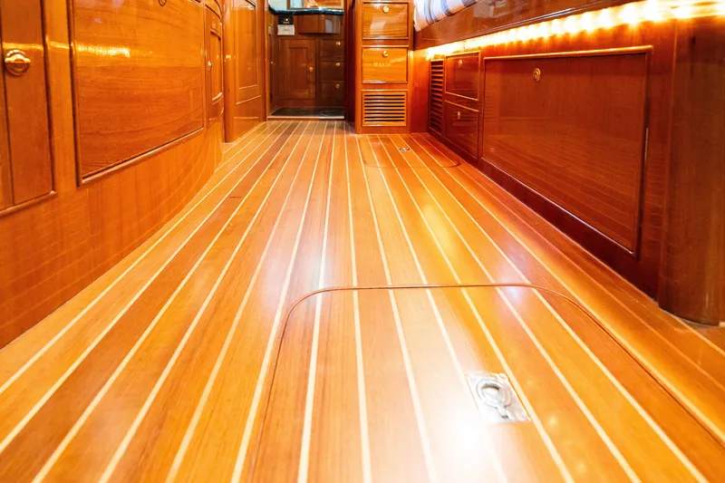 Slide: The Image of Luxurious wooden interior of a 2009 Marlow 61C yacht, featuring polished flooring and cabinetry. - 121