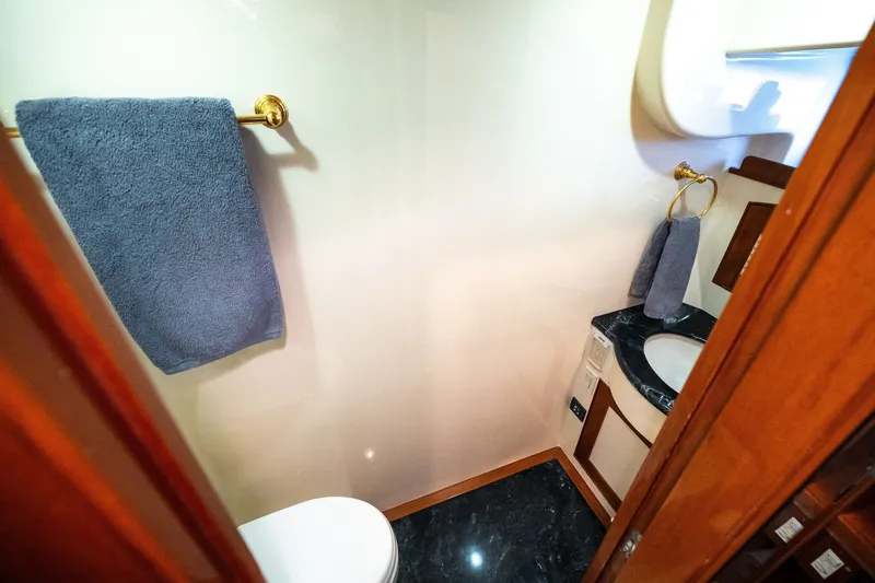 Slide: The Image of Luxurious Marlow 61C 2009 yacht bathroom with elegant fixtures and marble countertop. - 90