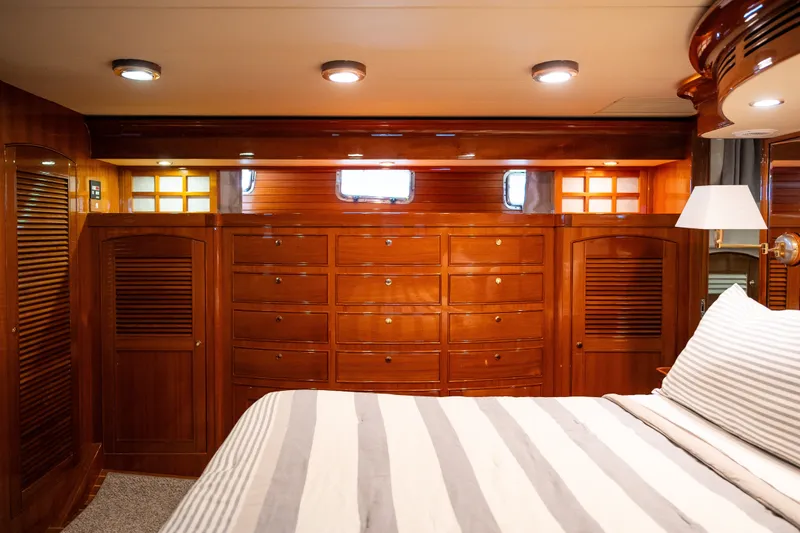 Slide: The Image of Luxurious wooden interior of 2009 Marlow 61C yacht cabin with striped bedding. - 106
