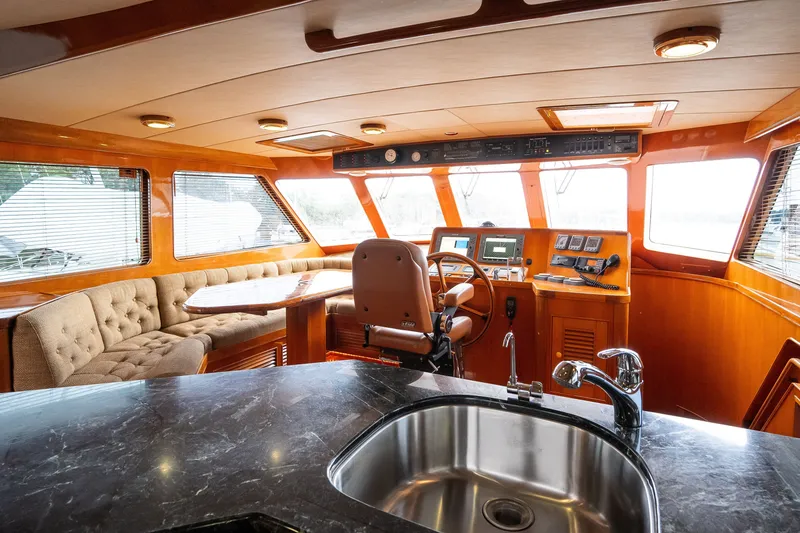 Slide: The Image of Luxurious 2009 Marlow 61C yacht interior with helm, plush seating, and modern amenities. - 46