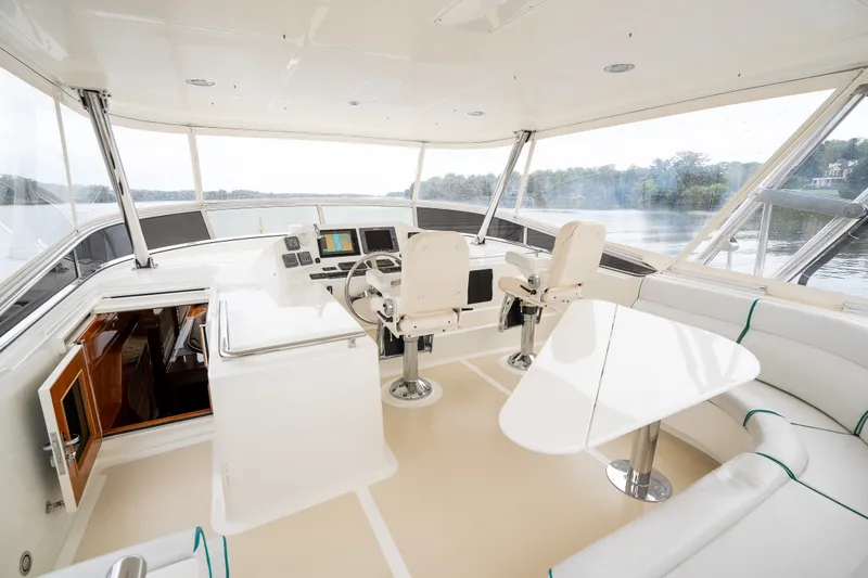 Slide: The Image of Luxurious 2009 Marlow 61C yacht interior with helm, seating, and panoramic windows. - 70