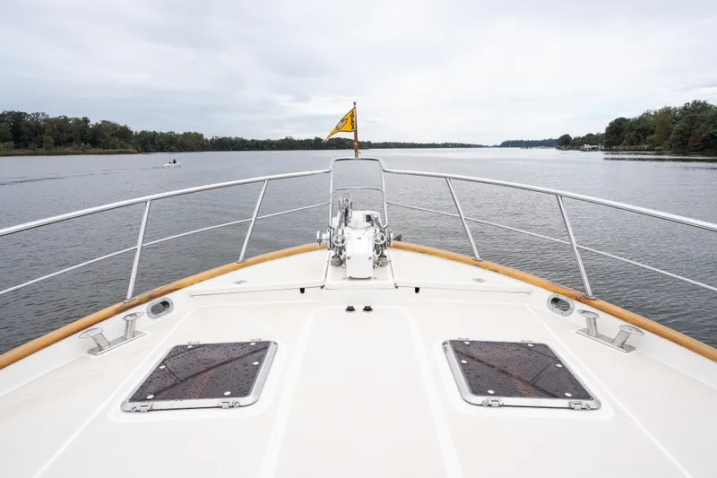 Slide: The Image of Bow view of 2009 Marlow 61C yacht cruising on a calm river. - 19