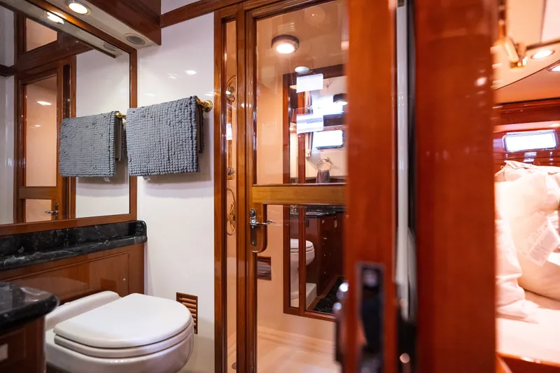 Slide: The Image of Luxurious bathroom interior on a 2009 Marlow 61C yacht, featuring elegant wood finishes. - 113