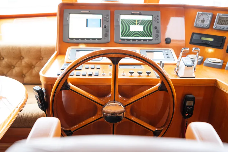 Slide: The Image of Steering wheel and control panel of 2009 Marlow 61C yacht cockpit. - 49
