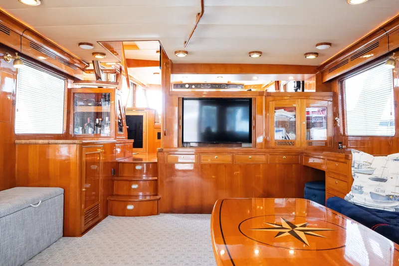 Slide: The Image of Luxurious interior of a 2009 Marlow 61C yacht with polished wood finishes and modern amenities. - 28