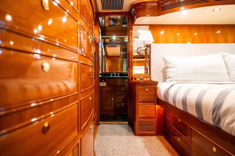 Slide: The Image of Luxurious Marlow 61C yacht interior with polished wood finish and cozy bedding, 2009 model. - 109