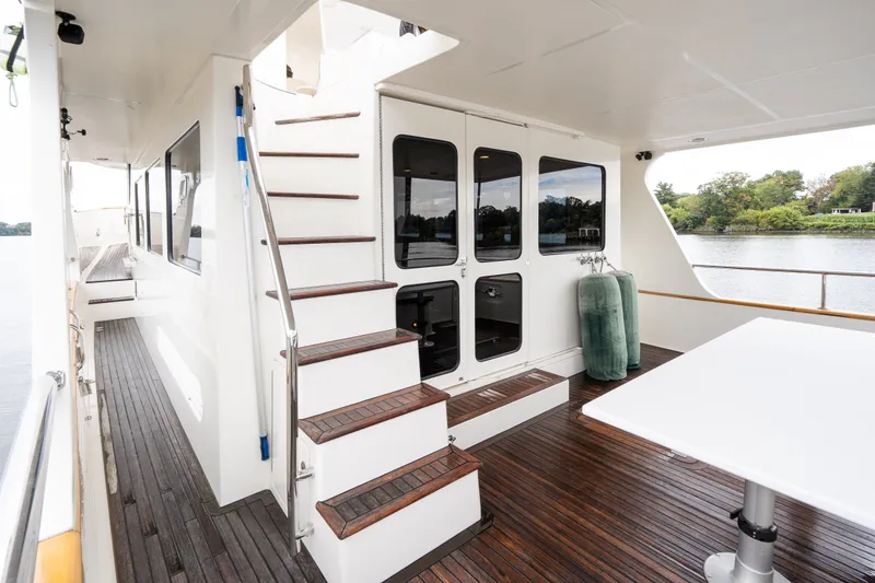 Slide: The Image of Luxurious 2009 Marlow 61C yacht deck with wooden flooring and elegant staircase. - 14