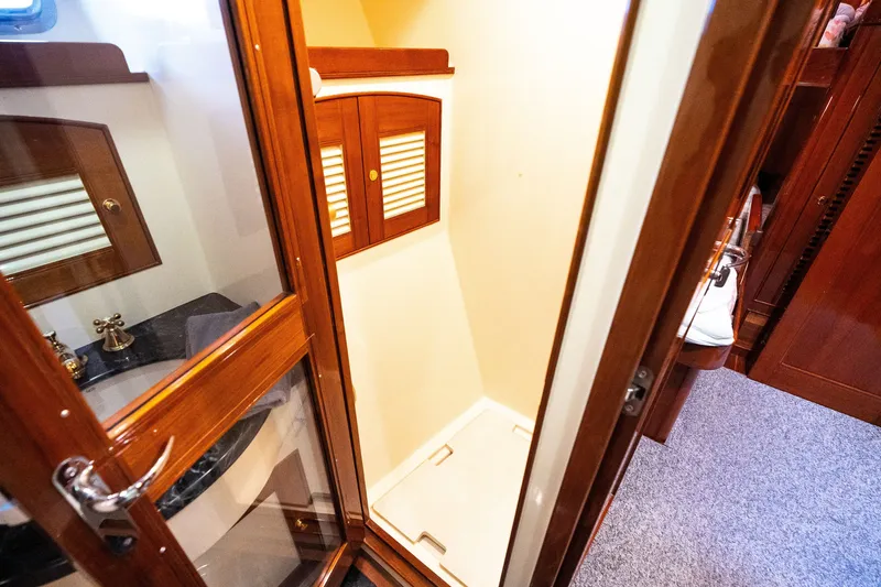 Slide: The Image of Luxurious wooden interior of 2009 Marlow 61C yacht bathroom with shower and sink. - 92