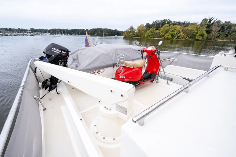 Slide: The Image of Marlow 61C yacht deck with red scooter and covered boat, 2009 model. - 78