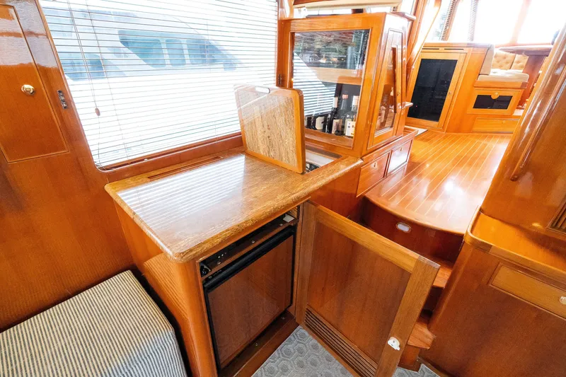 Slide: The Image of Luxurious wooden interior of a 2009 Marlow 61C yacht with built-in storage and seating. - 35