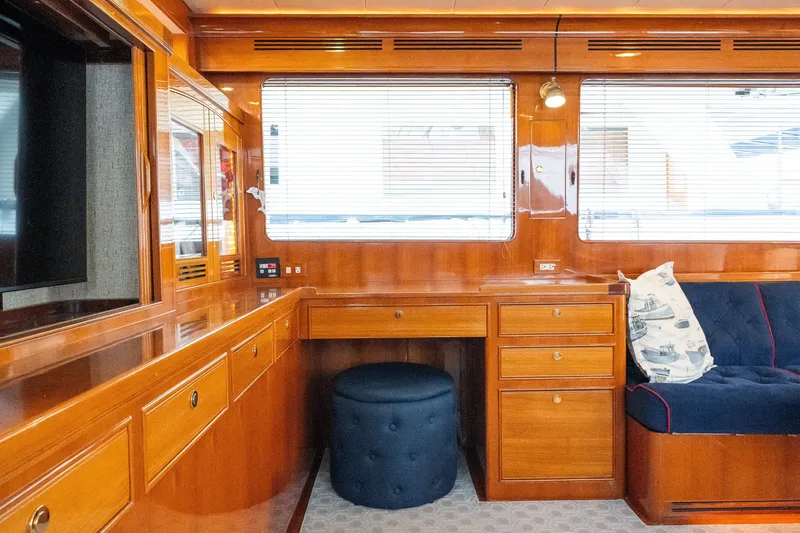 Slide: The Image of Luxurious wooden interior of a 2009 Marlow 61C yacht with seating and desk area. - 31