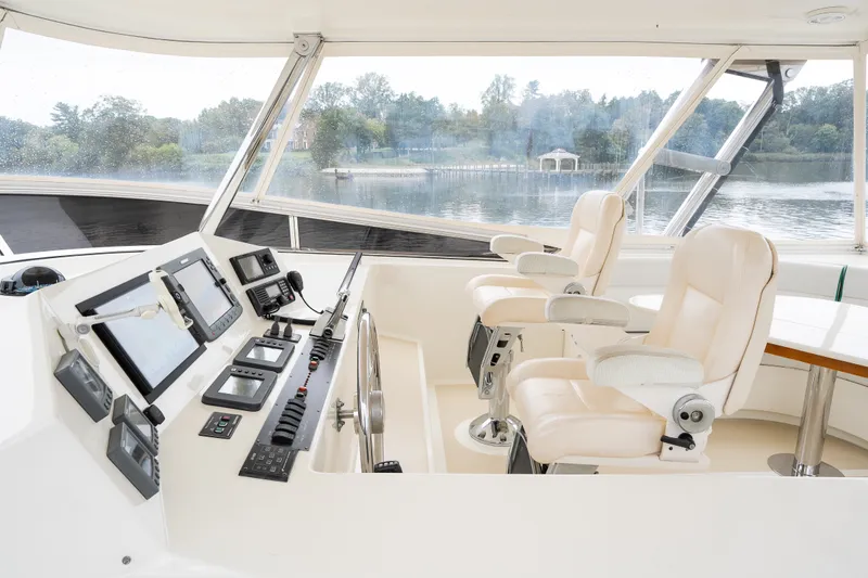 Slide: The Image of Helm of 2009 Marlow 61C yacht with navigation equipment and plush seating. - 71