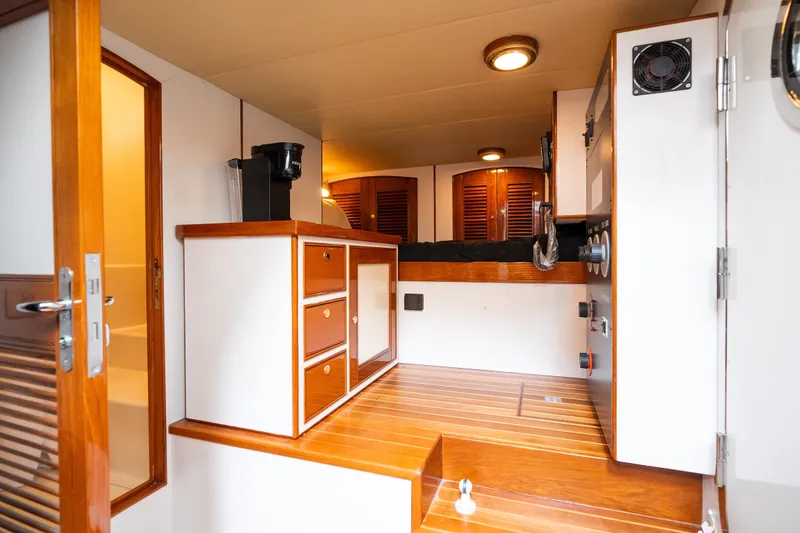 Slide: The Image of Interior of 2009 Marlow 61C yacht with wooden cabinetry and modern amenities. - 125