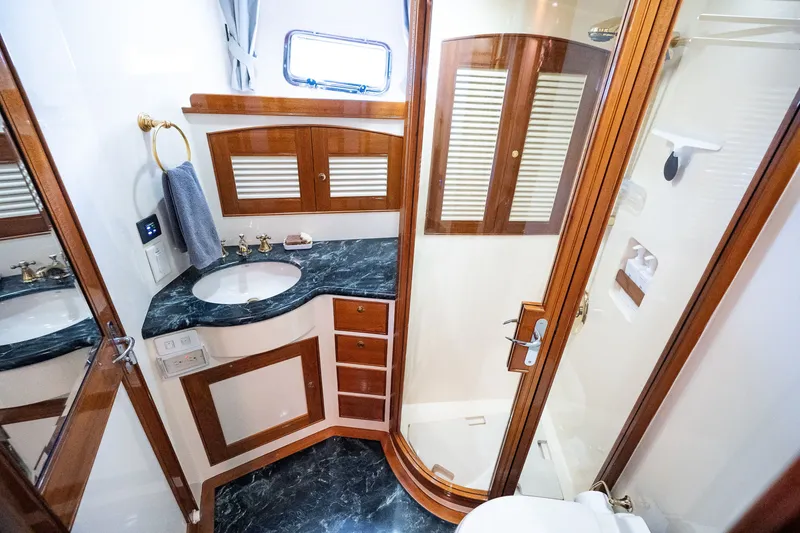 Slide: The Image of Luxurious Marlow 61C 2009 yacht bathroom with elegant wood accents and marble countertop. - 96