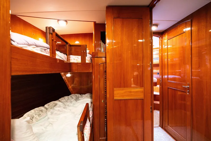 Slide: The Image of Luxurious wooden interior of 2009 Marlow 61C yacht with cozy bunk beds. - 86