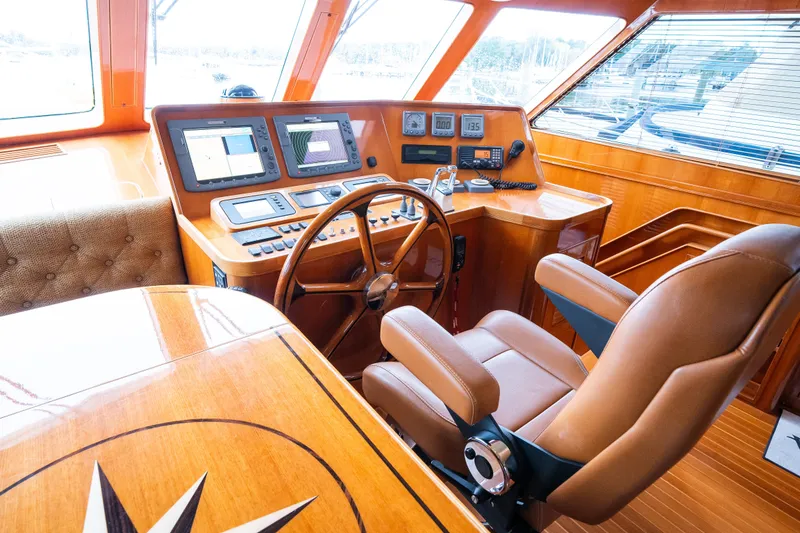 Slide: The Image of Luxurious 2009 Marlow 61C yacht helm with leather seating and advanced navigation systems. - 48