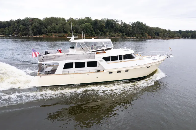 Slide: The Image of Luxury 2009 Marlow 61C yacht cruising on a serene lake with lush forest backdrop. - 143